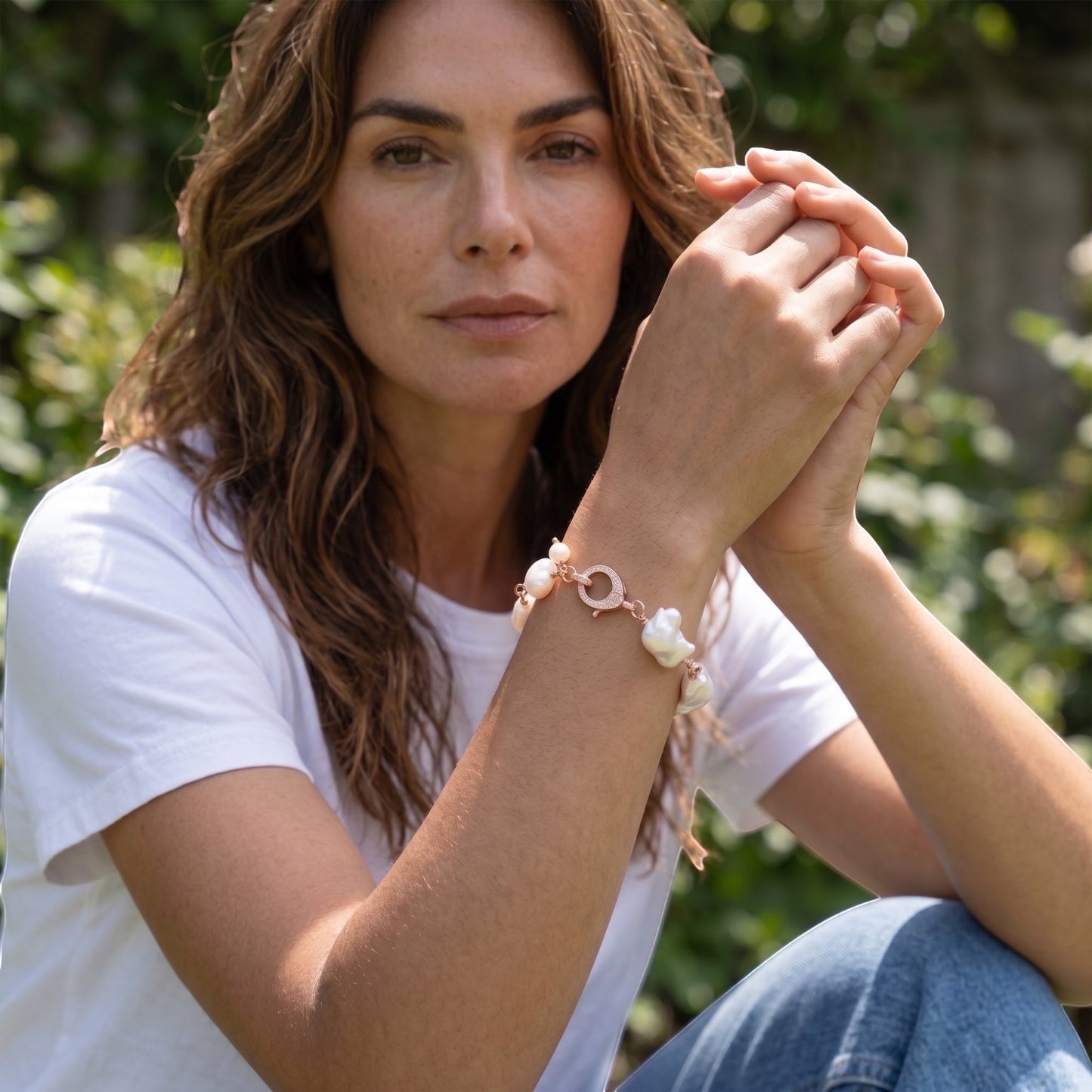 TSJ rose gold-tone bracelet with irregular white baroque pearls and a cubic zirconia clasp.