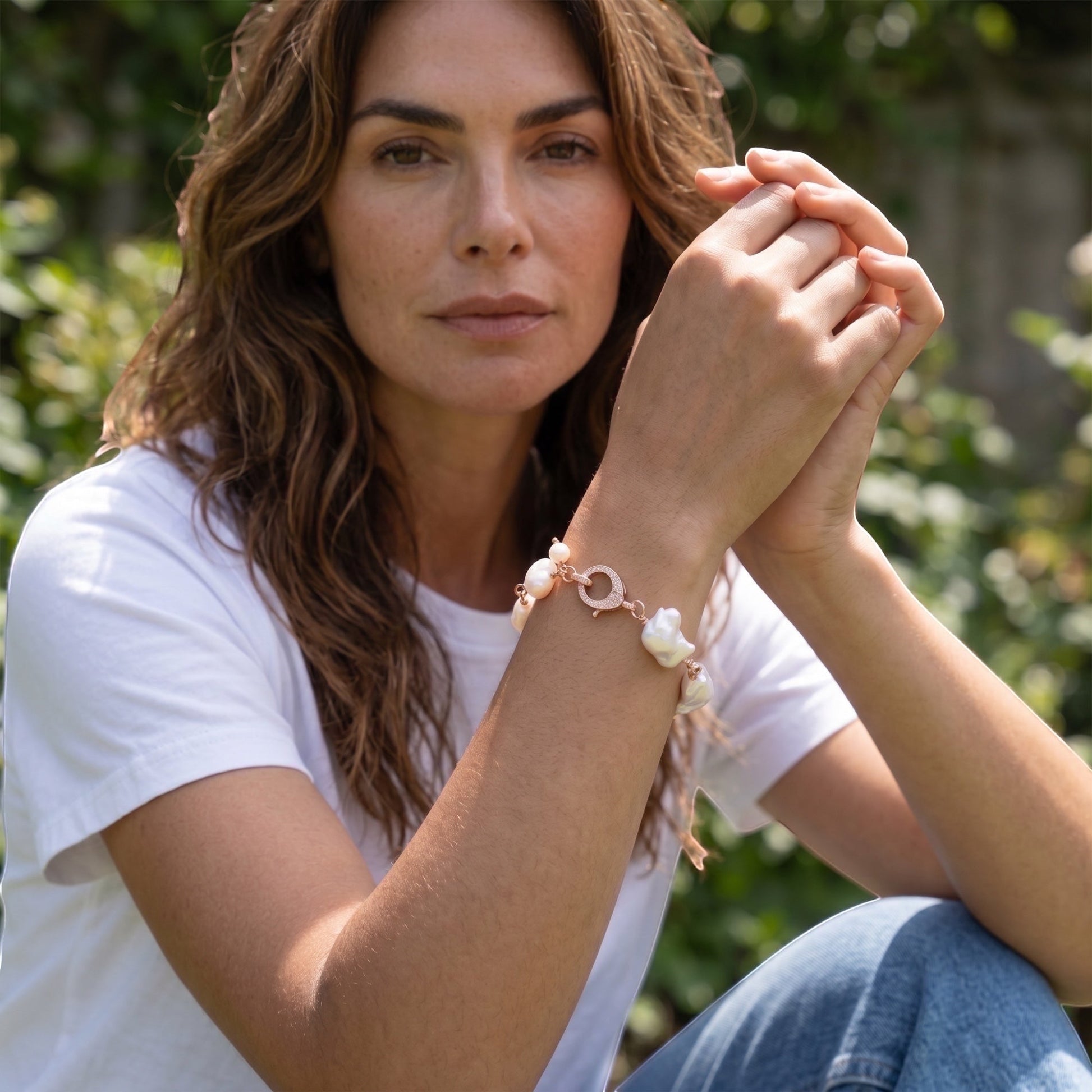 TSJ rose gold-tone bracelet with irregular white baroque pearls and a cubic zirconia clasp.