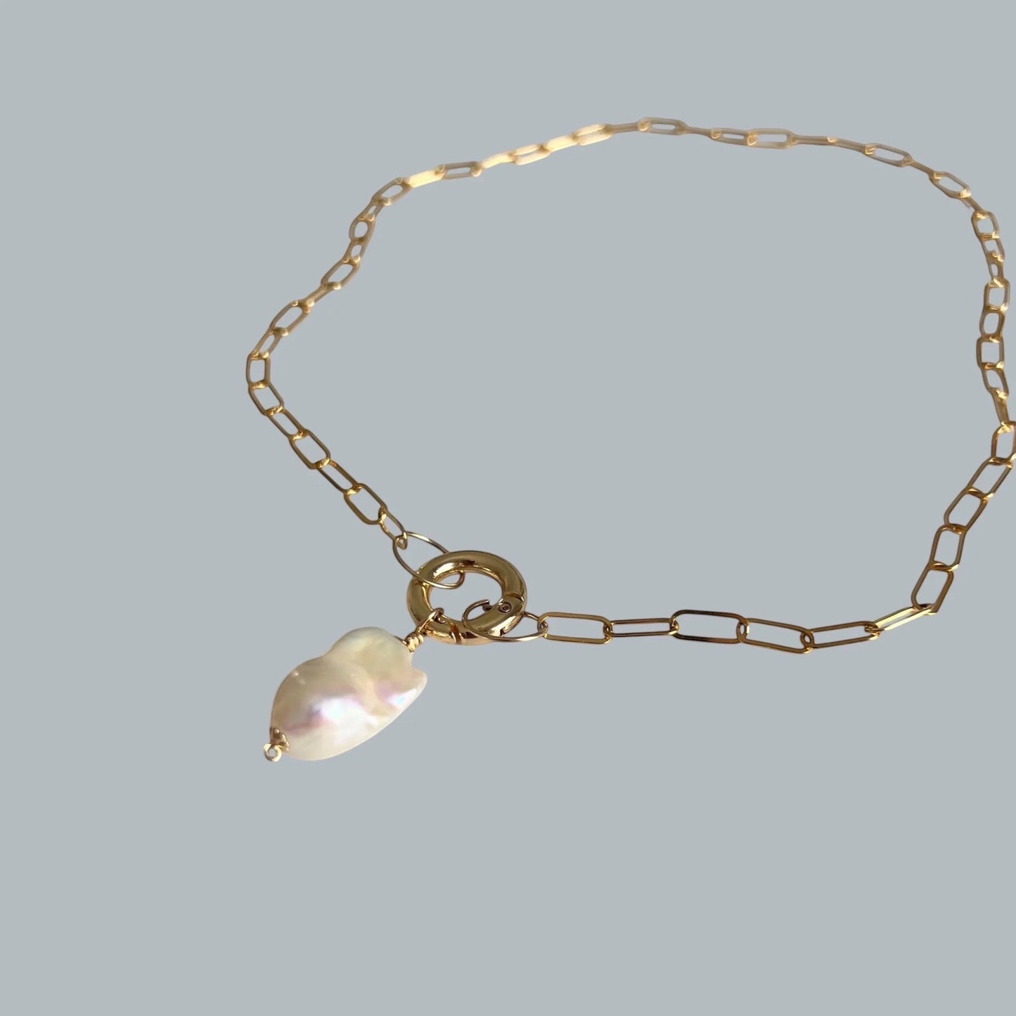 TSJ gold-tone chain necklace with baroque pearl charm and gold ring clasp. Unique freshwater pearl.