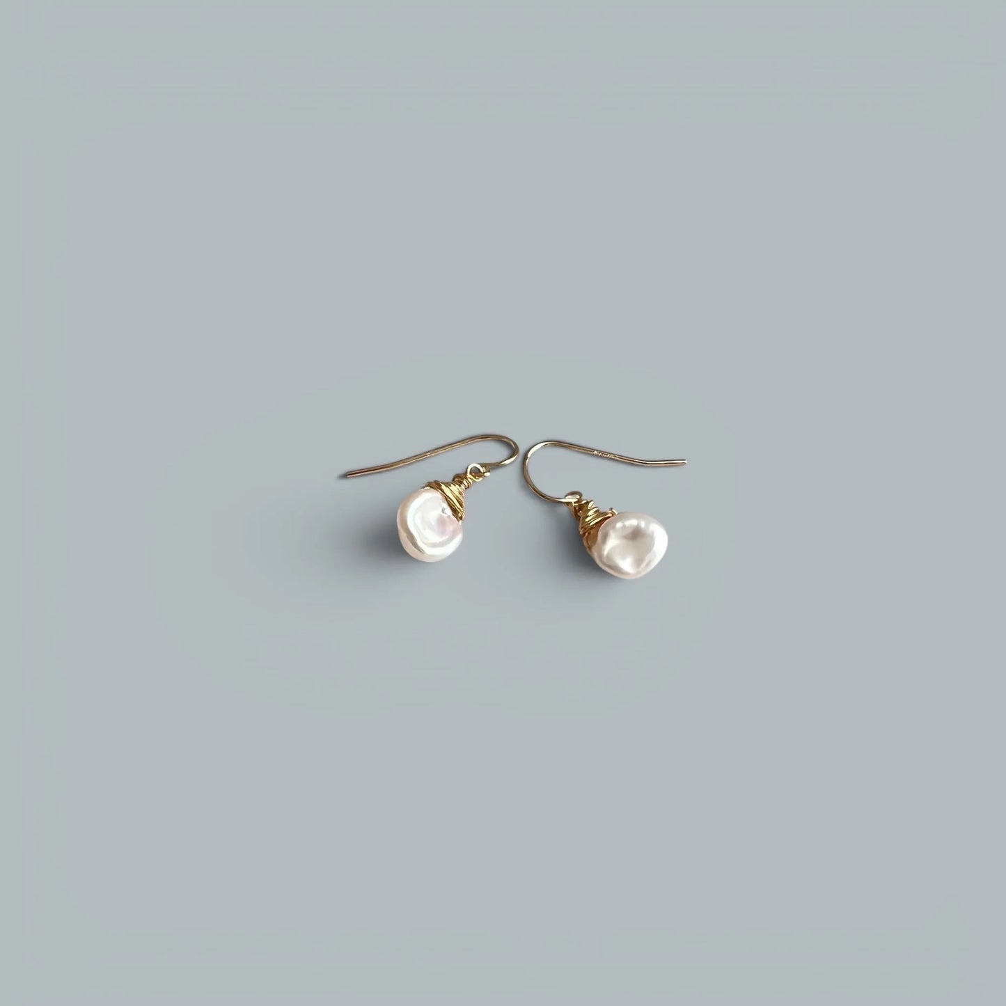 TSJ baroque freshwater pearl drop earrings with gold-tone wire wrap detail.