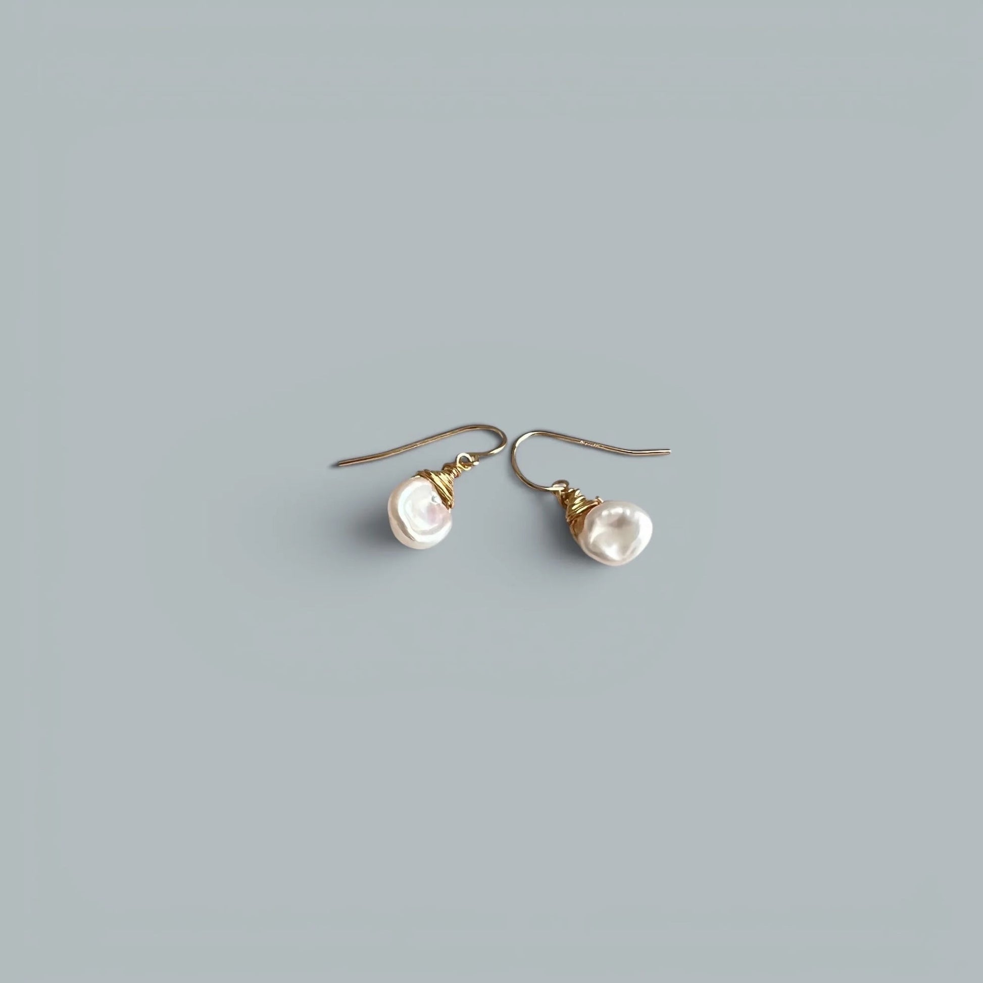 TSJ baroque freshwater pearl drop earrings with gold-tone wire wrap detail.