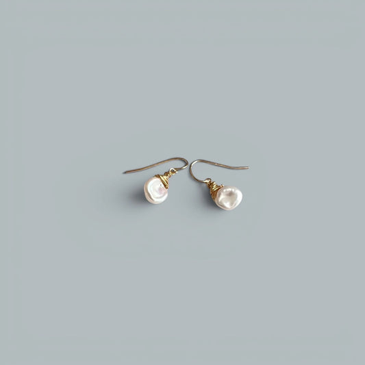 TSJ baroque freshwater pearl drop earrings with gold-tone wire wrap detail.
