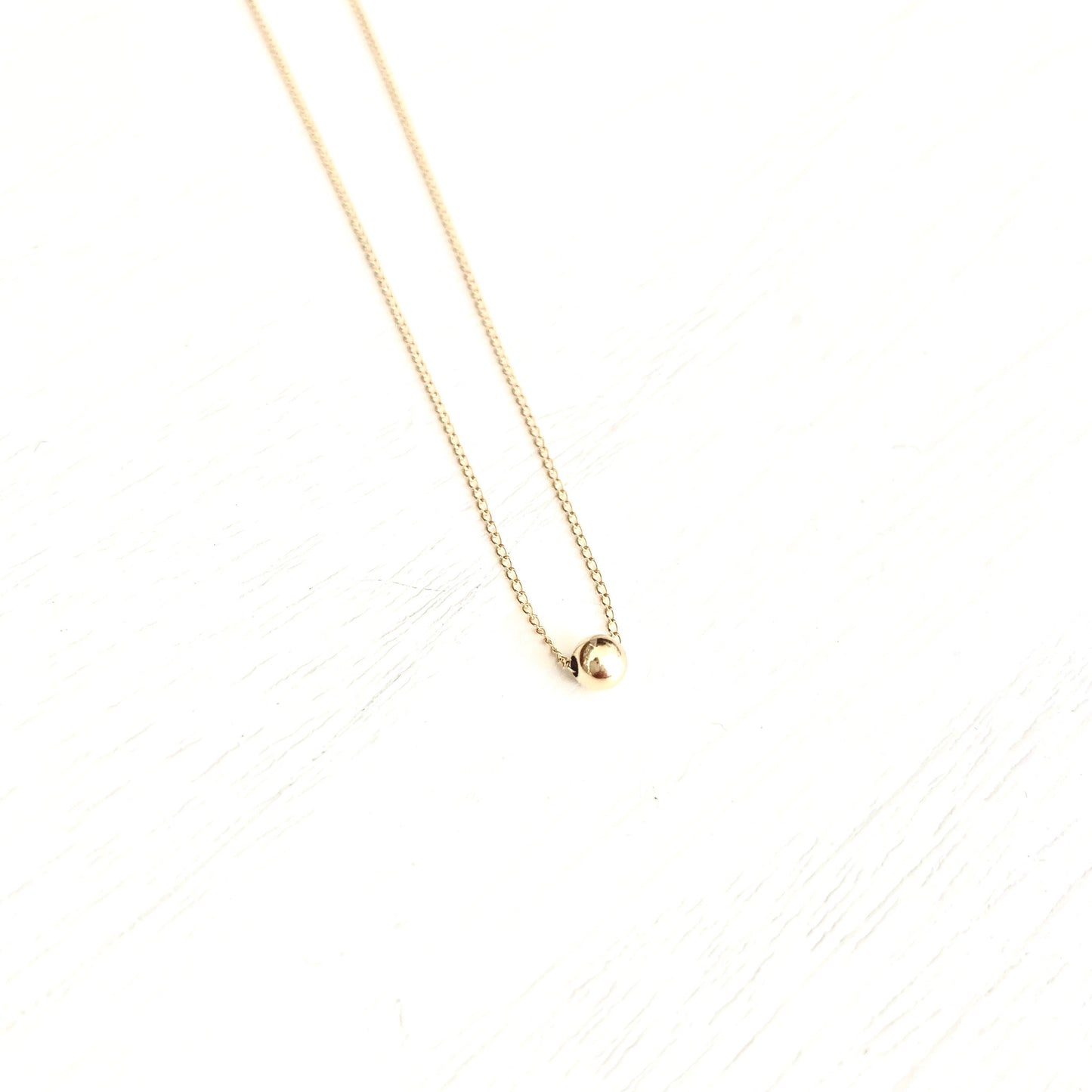 Betty single gold ball necklace